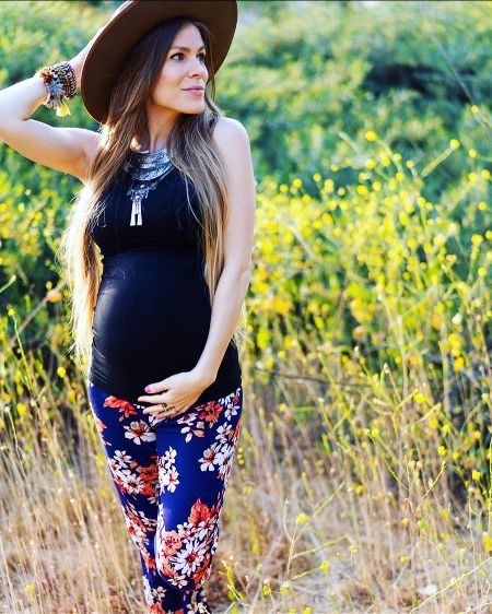 Danielle Donato in a black dress while pregnant.